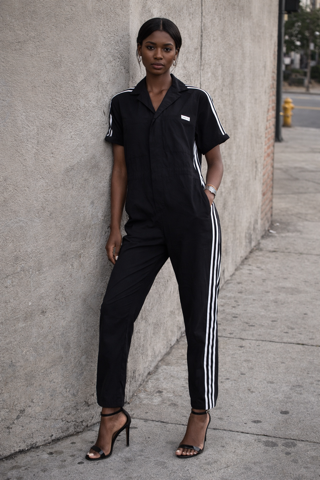Adidas Fiorucci Black Boiler Suit with three strip paneling worn on model with black heel sandals