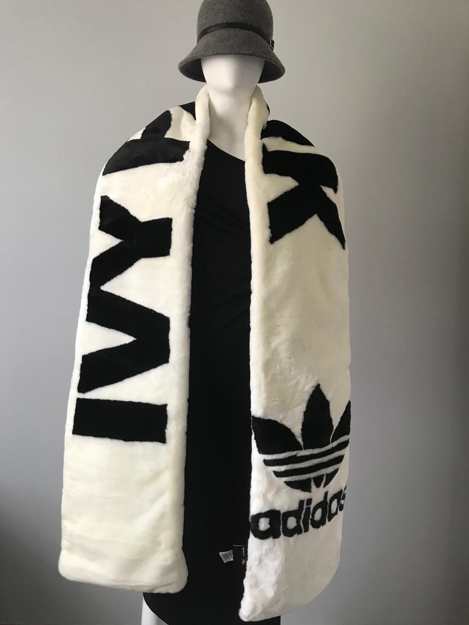 Adidas x Ivy Park oversized White Fur Scarf with bold black IVY PARK & Trefoil logo front view worn over mannequin